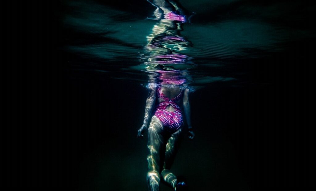 girl swimming underwater